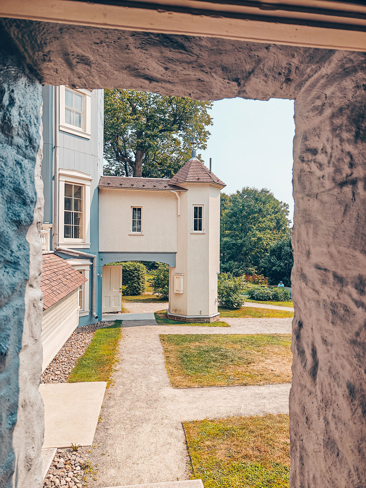Le manoir aperçu sous l’arche de pierre du passage