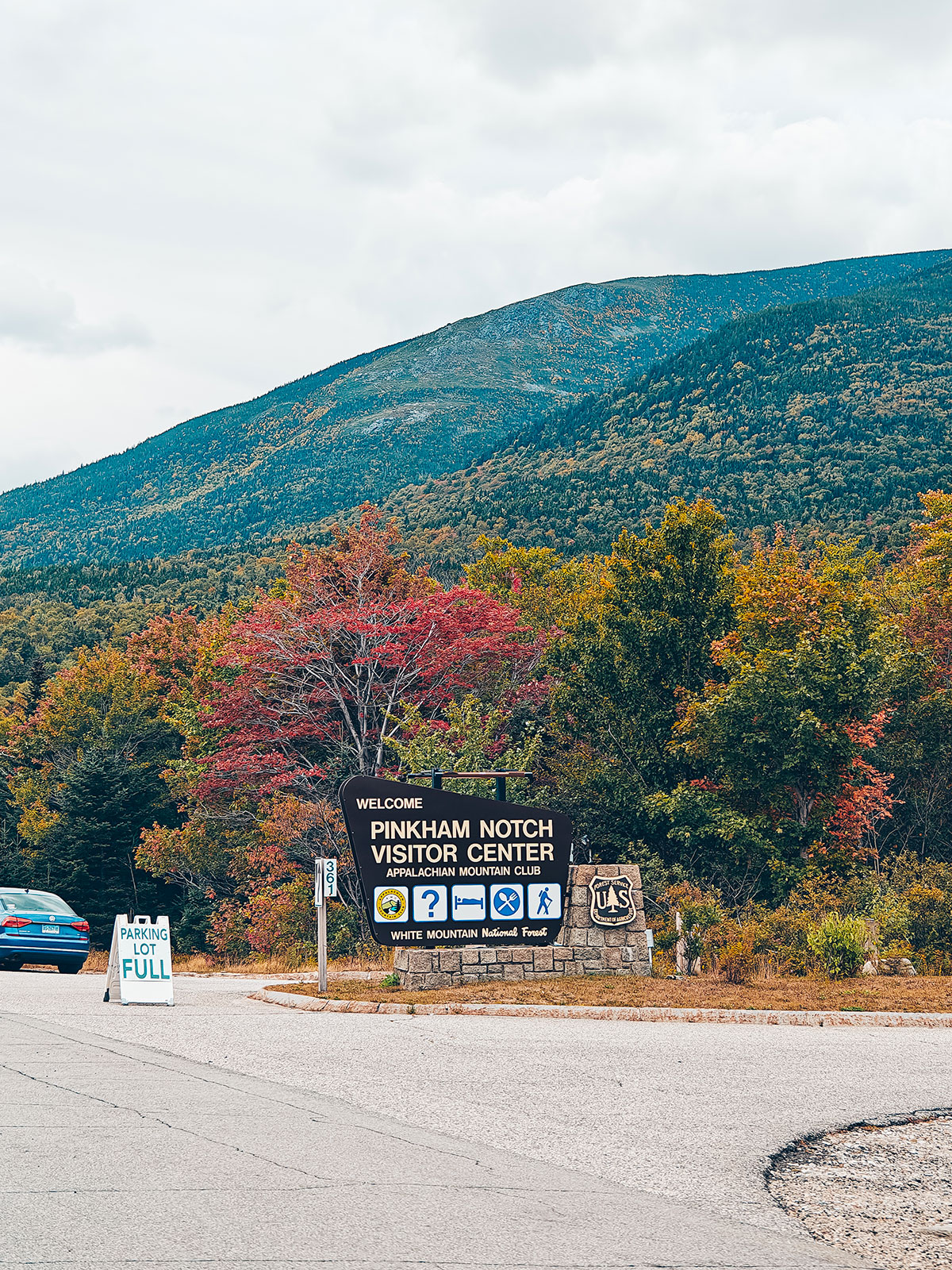 Le versant d'automne au-dessus du panneau du centre d'accueil de Pinkham Notch